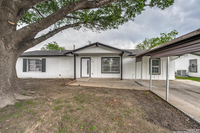 8010 Remuda, San Antonio, TX 78227 - ranch-style home with a shingled roof, central AC, brick siding, board and batten siding, and a patio area