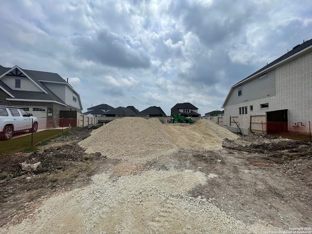 view of yard featuring a residential view and fence