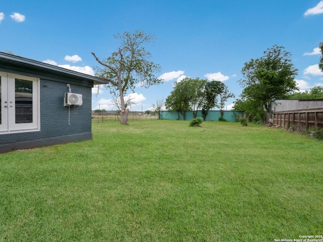 view of yard featuring a fenced backyard and ac unit