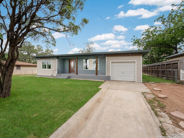 ranch-style home featuring fence, an attached garage, driveway, and a front yard
