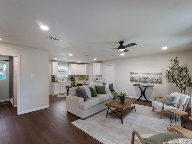 living room with dark wood-style flooring, recessed lighting, baseboards, a healthy amount of sunlight, and visible vents