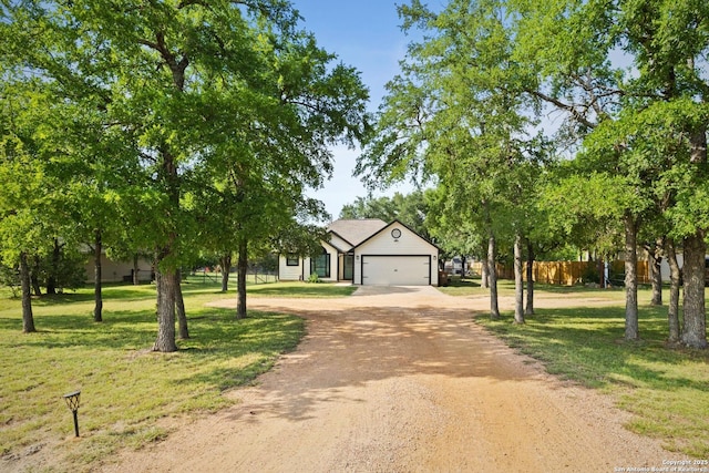 113 E Dawn Dr, Johnson City, TX 78636 - view of front of house with a garage, fence, dirt driveway, and a front lawn