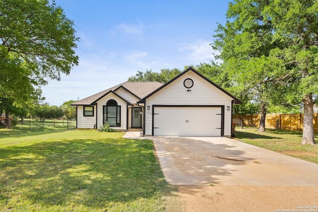 113 E Dawn Dr, Johnson City, TX 78636 - single story home featuring a garage, fence, driveway, and a front lawn