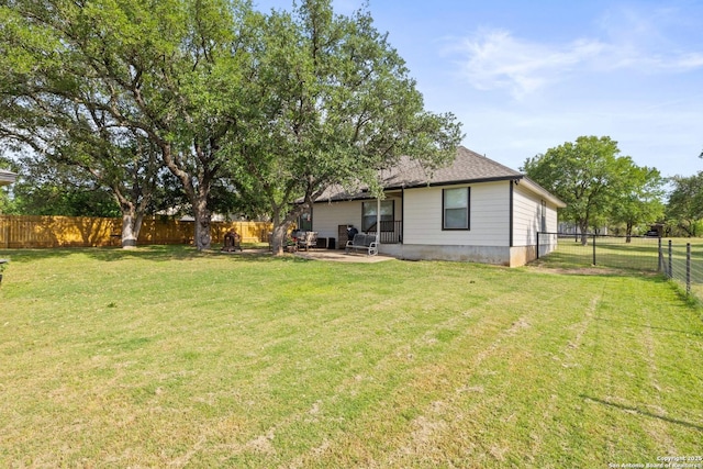 113 E Dawn Dr, Johnson City, TX 78636 - rear view of property with a fenced backyard, a patio area, and a yard