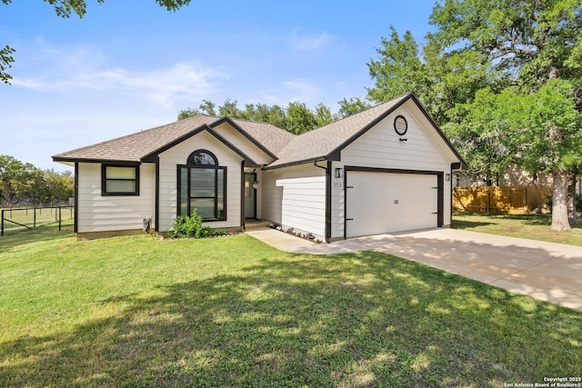 113 E Dawn Dr, Johnson City, TX 78636 - single story home with fence, an attached garage, concrete driveway, and a front lawn