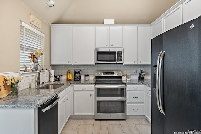 113 E Dawn Dr, Johnson City, TX 78636 - kitchen featuring a sink, white cabinetry, tasteful backsplash, and stainless steel appliances