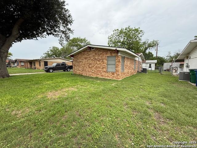 4519 Creekmoor, San Antonio, TX 78220 - view of home's exterior featuring cooling unit and brick siding