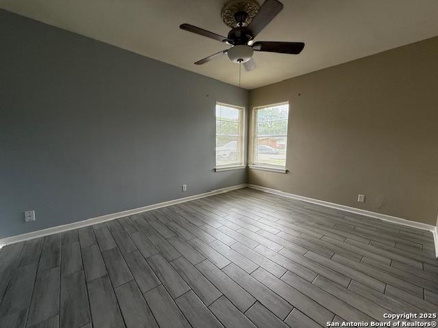 4519 Creekmoor, San Antonio, TX 78220 - spare room with a ceiling fan, dark wood finished floors, and baseboards