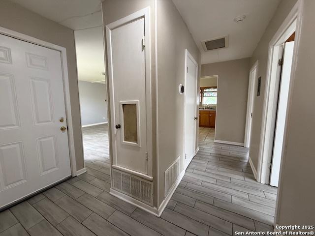 4519 Creekmoor, San Antonio, TX 78220 - hallway featuring wood finish floors and baseboards