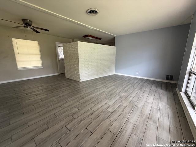 4519 Creekmoor, San Antonio, TX 78220 - empty room with dark wood-style flooring, ceiling fan, baseboards, and plenty of natural light