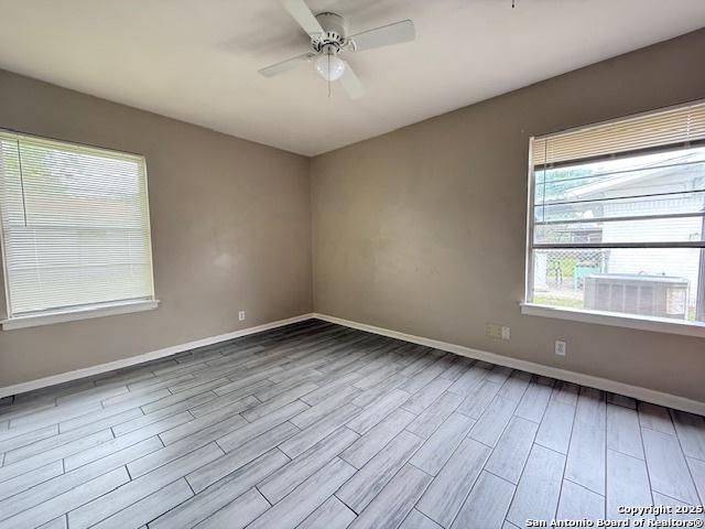 4519 Creekmoor, San Antonio, TX 78220 - spare room featuring wood finished floors, baseboards, and a ceiling fan