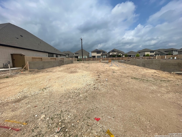view of yard featuring a residential view and fence