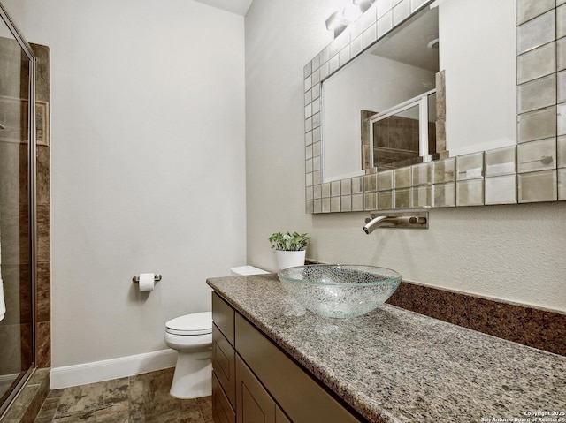 7211 Cresta Bulivar, San Antonio, TX 78256 - bathroom with vanity, toilet, baseboards, and a stall shower