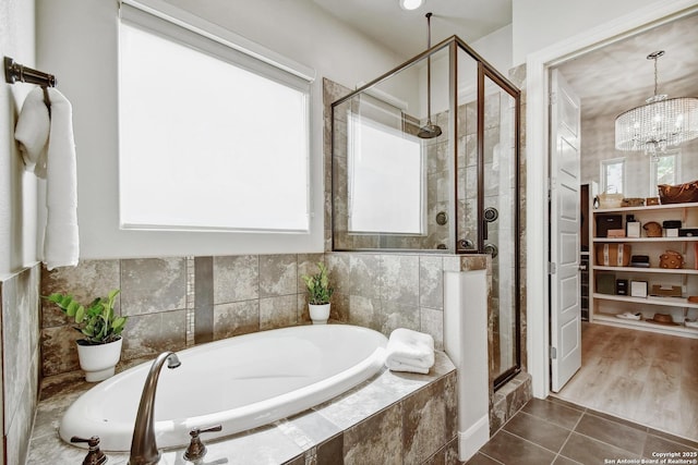 7211 Cresta Bulivar, San Antonio, TX 78256 - full bath with an inviting chandelier, tile patterned flooring, a stall shower, and a garden tub