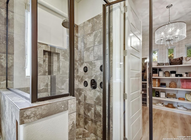 7211 Cresta Bulivar, San Antonio, TX 78256 - full bathroom with wood finished floors, a chandelier, and a tile shower