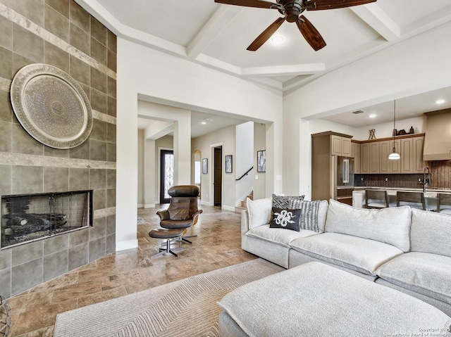 7211 Cresta Bulivar, San Antonio, TX 78256 - living room featuring beamed ceiling, stairway, recessed lighting, a tile fireplace, and a ceiling fan