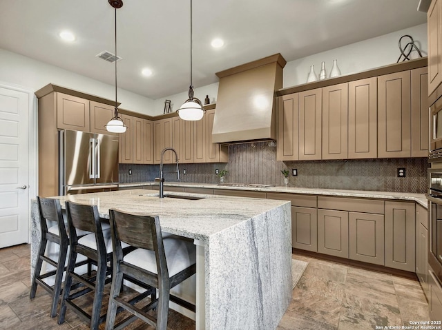 7211 Cresta Bulivar, San Antonio, TX 78256 - kitchen featuring visible vents, a center island with sink, premium range hood, a sink, and stainless steel appliances