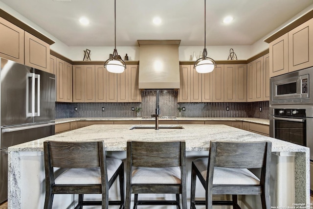 7211 Cresta Bulivar, San Antonio, TX 78256 - kitchen with appliances with stainless steel finishes, hanging light fixtures, custom range hood, and an island with sink