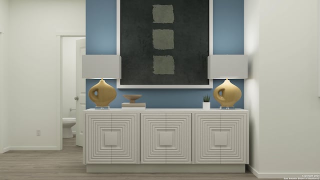 interior space featuring baseboards and wood finished floors