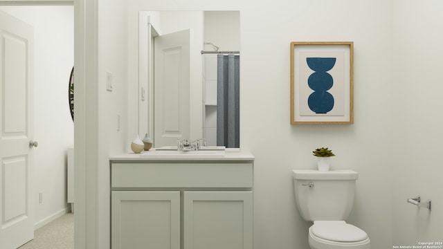 bathroom featuring vanity, baseboards, and toilet