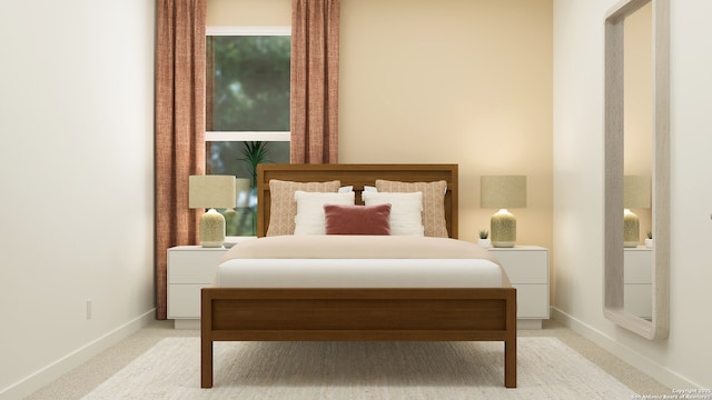 bedroom with baseboards and light colored carpet