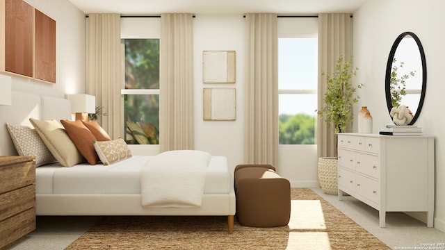 bedroom with baseboards and light colored carpet