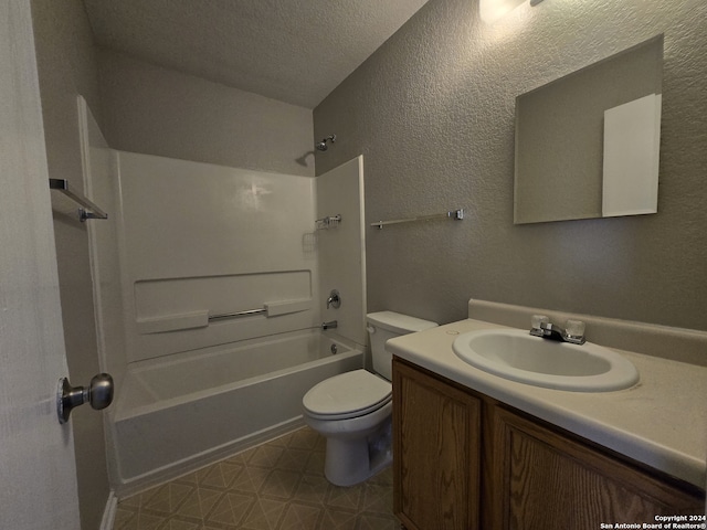 full bath with vanity, a textured wall, toilet, and a textured ceiling