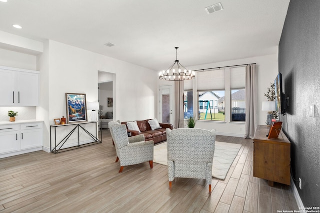 140 Cordova, Boerne, TX 78006 - living room featuring light wood-style flooring, a chandelier, and baseboards