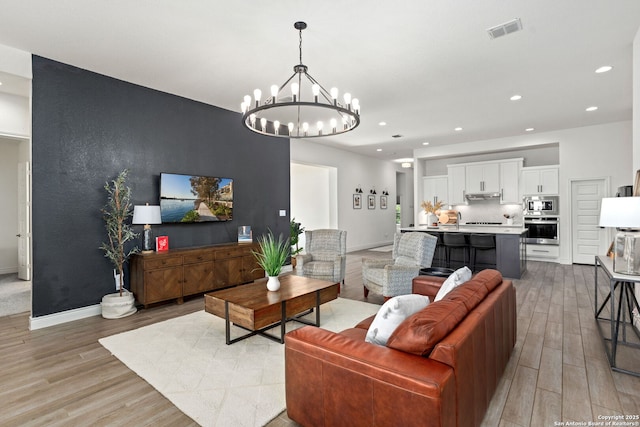 140 Cordova, Boerne, TX 78006 - living room with light wood-type flooring, a chandelier, recessed lighting, and baseboards