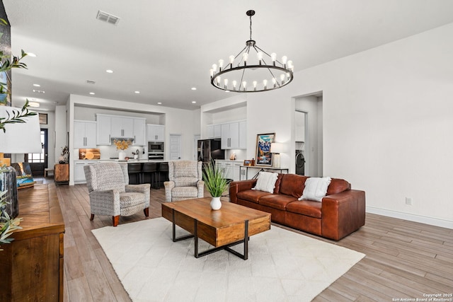 140 Cordova, Boerne, TX 78006 - living room with a chandelier, light wood finished floors, recessed lighting, and baseboards