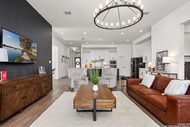 140 Cordova, Boerne, TX 78006 - living area with a chandelier, light wood finished floors, and recessed lighting