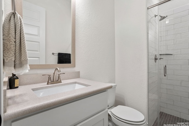 140 Cordova, Boerne, TX 78006 - full bathroom featuring a stall shower, vanity, toilet, and a textured wall