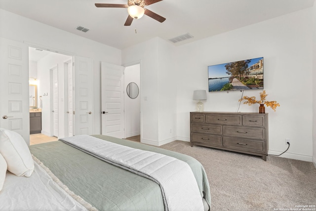 140 Cordova, Boerne, TX 78006 - bedroom with baseboards, light carpet, ceiling fan, and ensuite bathroom