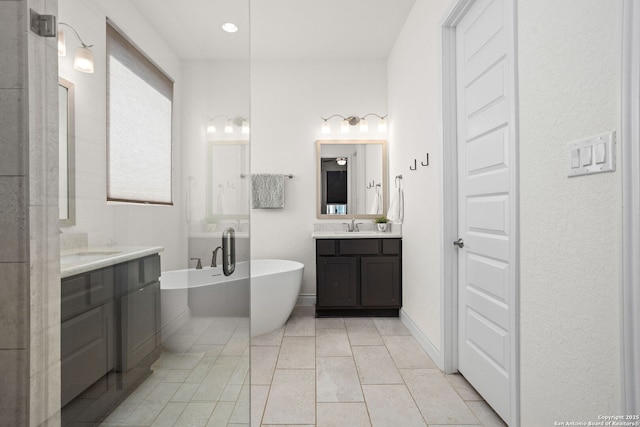 140 Cordova, Boerne, TX 78006 - bathroom featuring two vanities, a freestanding bath, and tile patterned floors