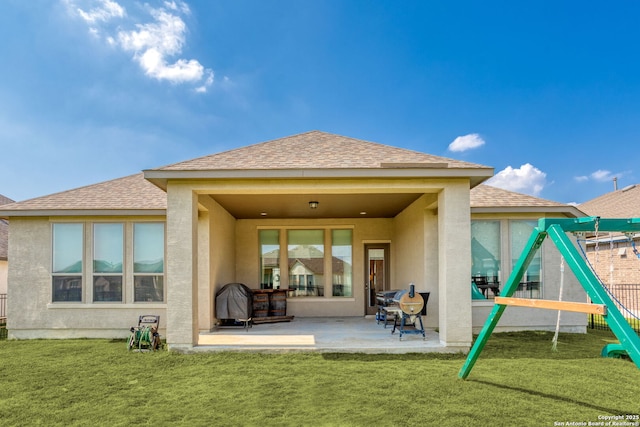140 Cordova, Boerne, TX 78006 - rear view of house featuring a shingled roof, stucco siding, a patio, and a yard