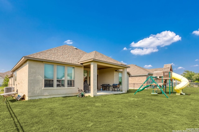 140 Cordova, Boerne, TX 78006 - rear view of property featuring central AC, stucco siding, a patio area, a playground, and roof with shingles