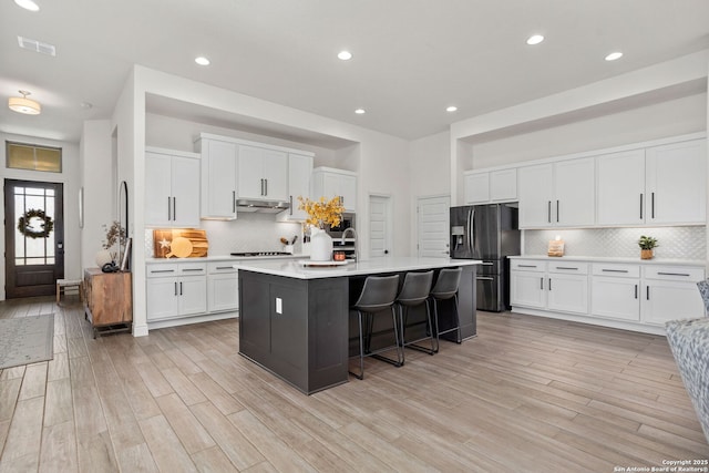 140 Cordova, Boerne, TX 78006 - kitchen featuring stainless steel fridge, backsplash, light wood-style floors, light countertops, and recessed lighting