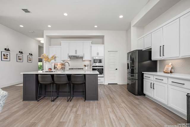 140 Cordova, Boerne, TX 78006 - kitchen featuring appliances with stainless steel finishes, tasteful backsplash, light countertops, recessed lighting, and white cabinetry