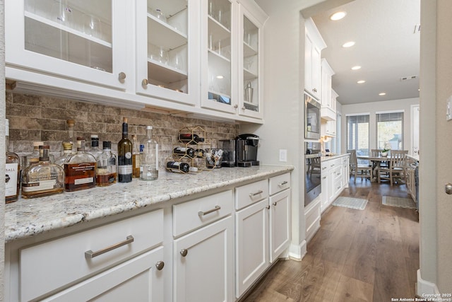 bar featuring recessed lighting, appliances with stainless steel finishes, dark wood-style floors, and tasteful backsplash