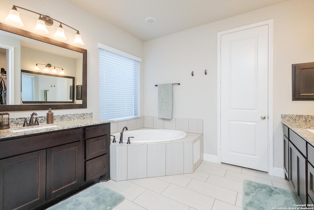 full bath with a garden tub, tile patterned flooring, two vanities, a sink, and a closet