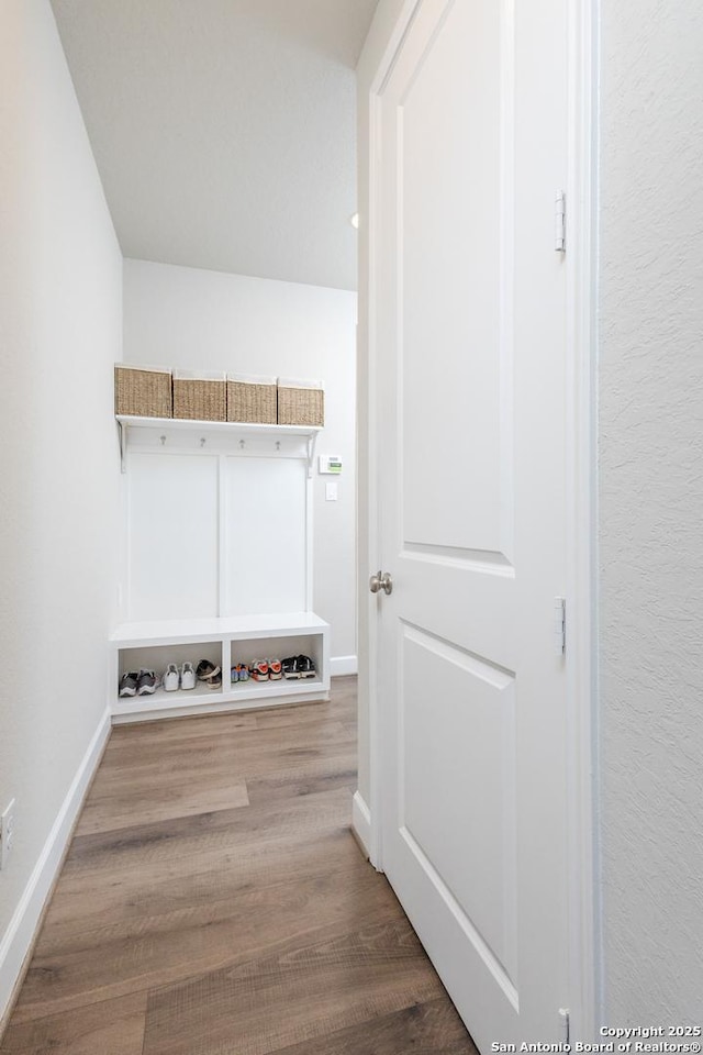 mudroom with baseboards and wood finished floors