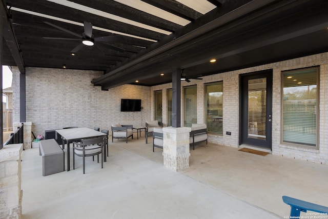 view of patio with a ceiling fan, outdoor dining area, and an outdoor living space