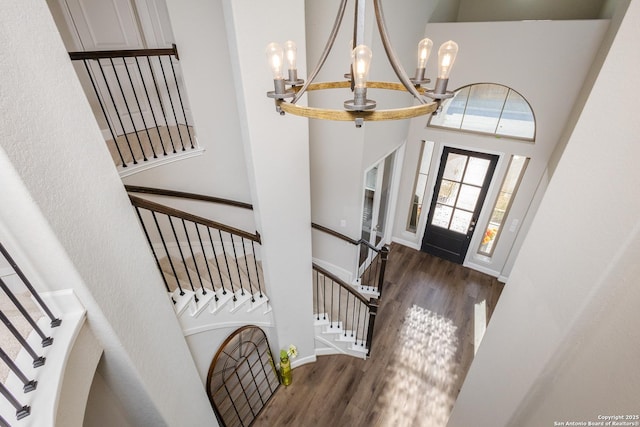 entryway featuring a high ceiling, a chandelier, and stairway