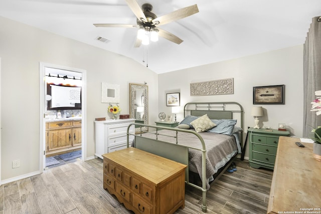 bedroom featuring a ceiling fan, visible vents, wood finished floors, and lofted ceiling