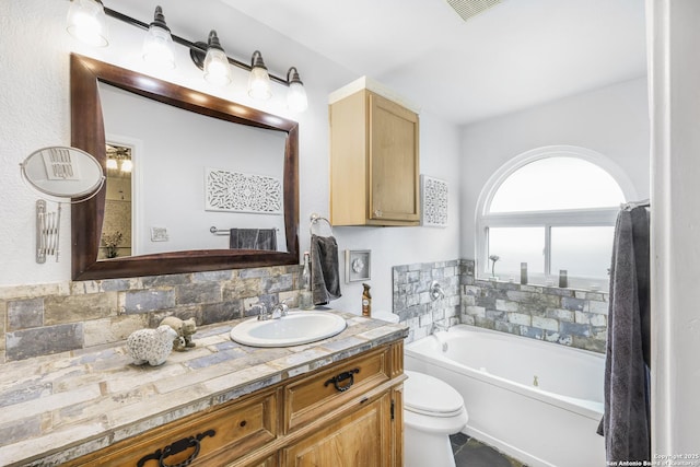 full bath with vanity, toilet, decorative backsplash, visible vents, and a bath