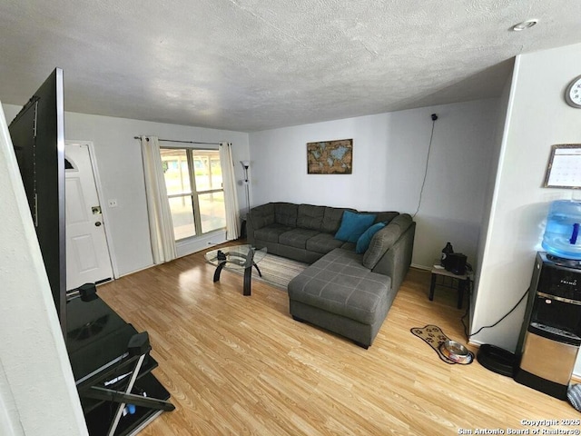 4802 Castle Brg, San Antonio, TX 78218 - living area featuring wood finished floors and a textured ceiling
