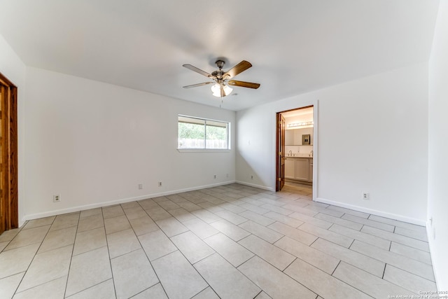 10526 Tioga, San Antonio, TX 78230 - spare room featuring light tile patterned floors, ceiling fan, and baseboards