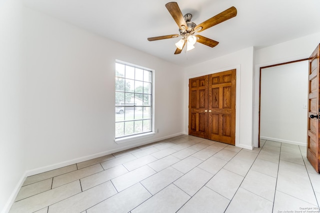 10526 Tioga, San Antonio, TX 78230 - unfurnished bedroom with light tile patterned floors, baseboards, and ceiling fan