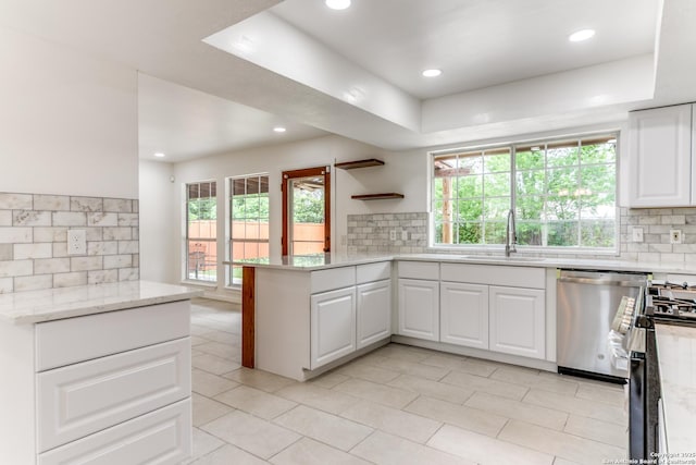 10526 Tioga, San Antonio, TX 78230 - kitchen with a sink, decorative backsplash, stainless steel dishwasher, and a peninsula