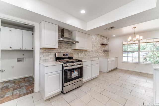 10526 Tioga, San Antonio, TX 78230 - kitchen featuring visible vents, baseboards, wall chimney range hood, and stainless steel gas range